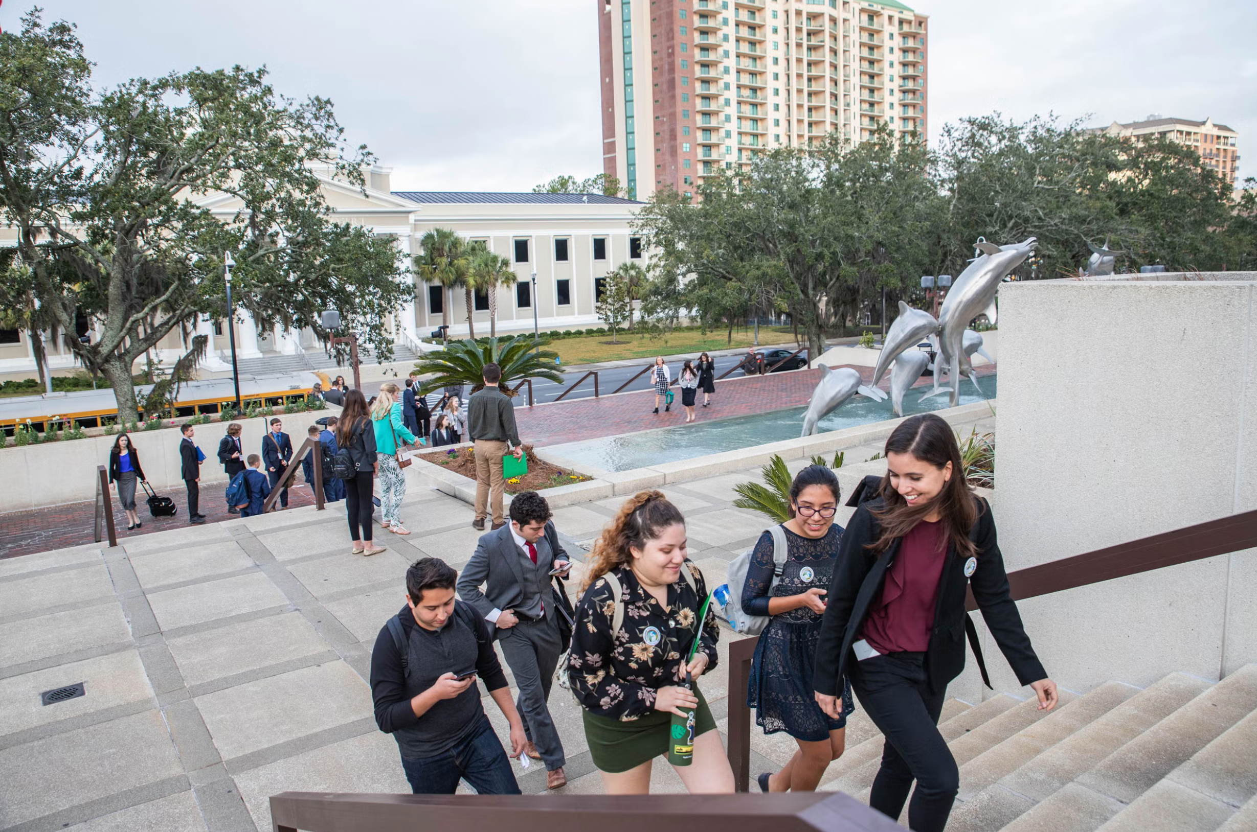 A group of people climb a flight of stairs